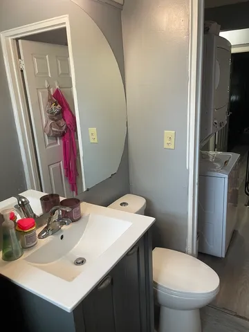 a bathroom with a sink vanity mirror and toilet