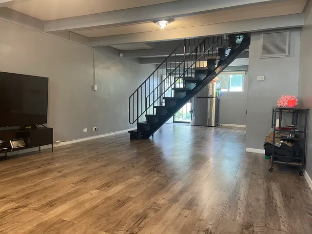 a view of a livingroom with furniture and a flat screen tv
