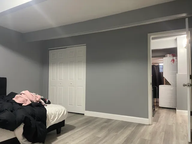 a bedroom with a bed and a closet