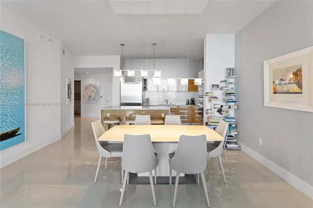a large kitchen with dining table and chairs