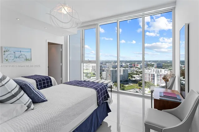 a bedroom with a large window and a bed