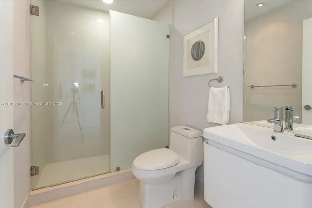 a bathroom with a toilet sink and shower