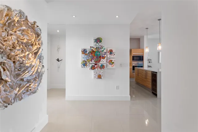 a view of a hallway with workspace and a chandelier