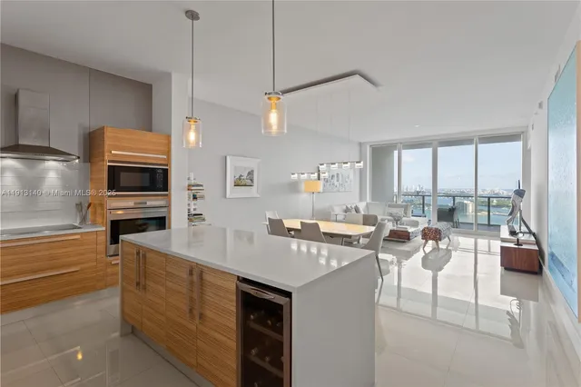a kitchen with a sink a counter top space appliances and cabinets