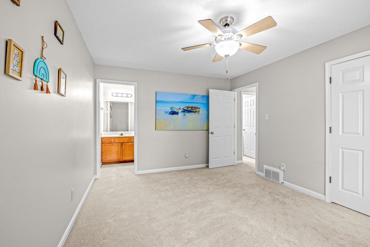 4840 Rainy Pass Road Collierville, TN 38017 - Photo 19 of 30 Bedroom featuring light gray wall paint, neutral carpeting, and a ceiling fan with integrated lighting
