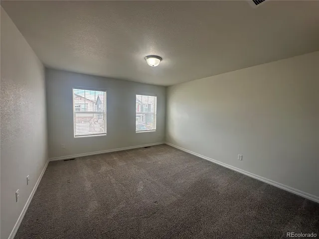 a spacious bathroom with a granite countertop sink a mirror and a shower