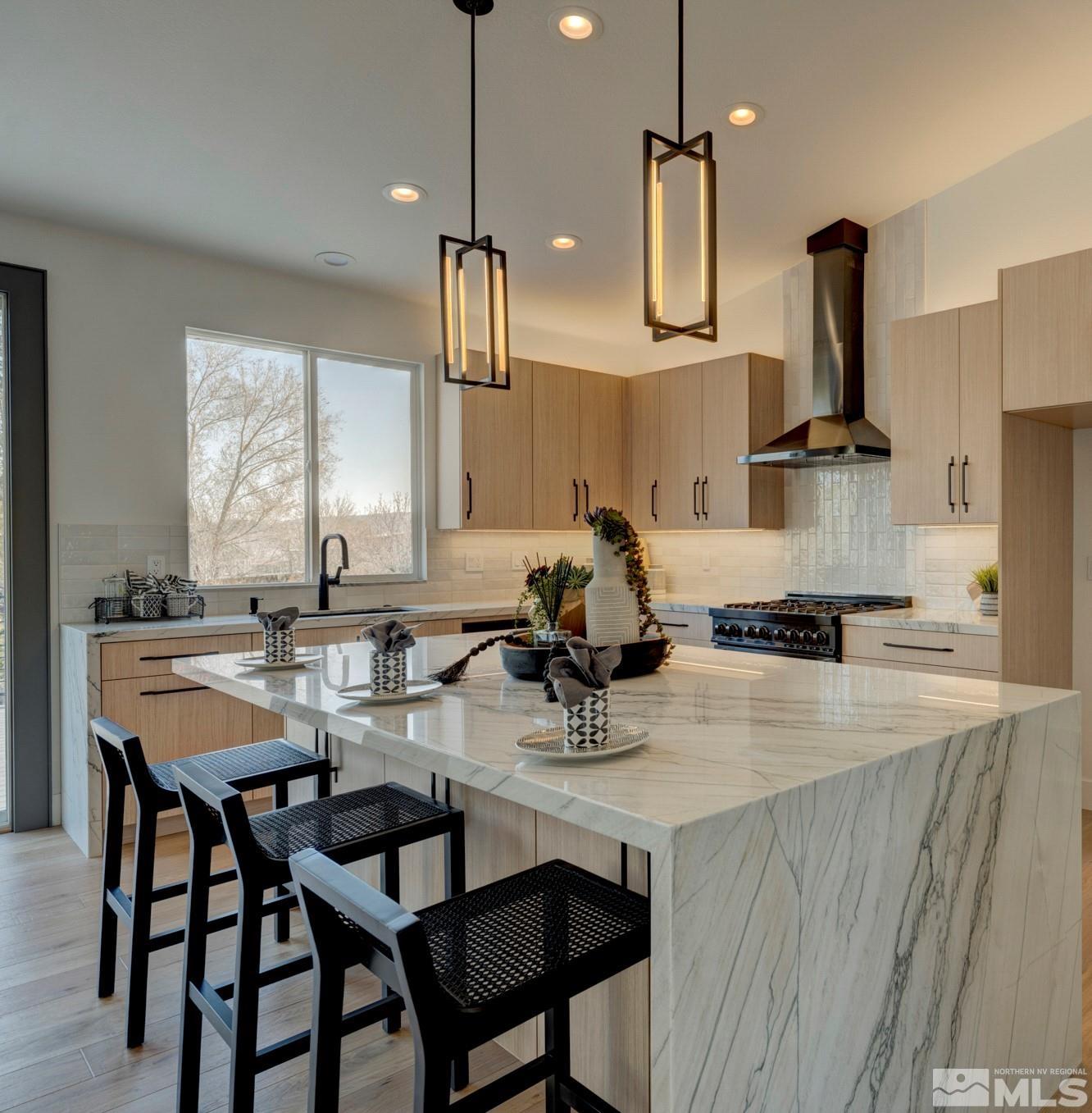1095 Flanders Road Reno, NV 89511 - Photo 11 of 39 a kitchen with stainless steel appliances a sink a stove and chairs