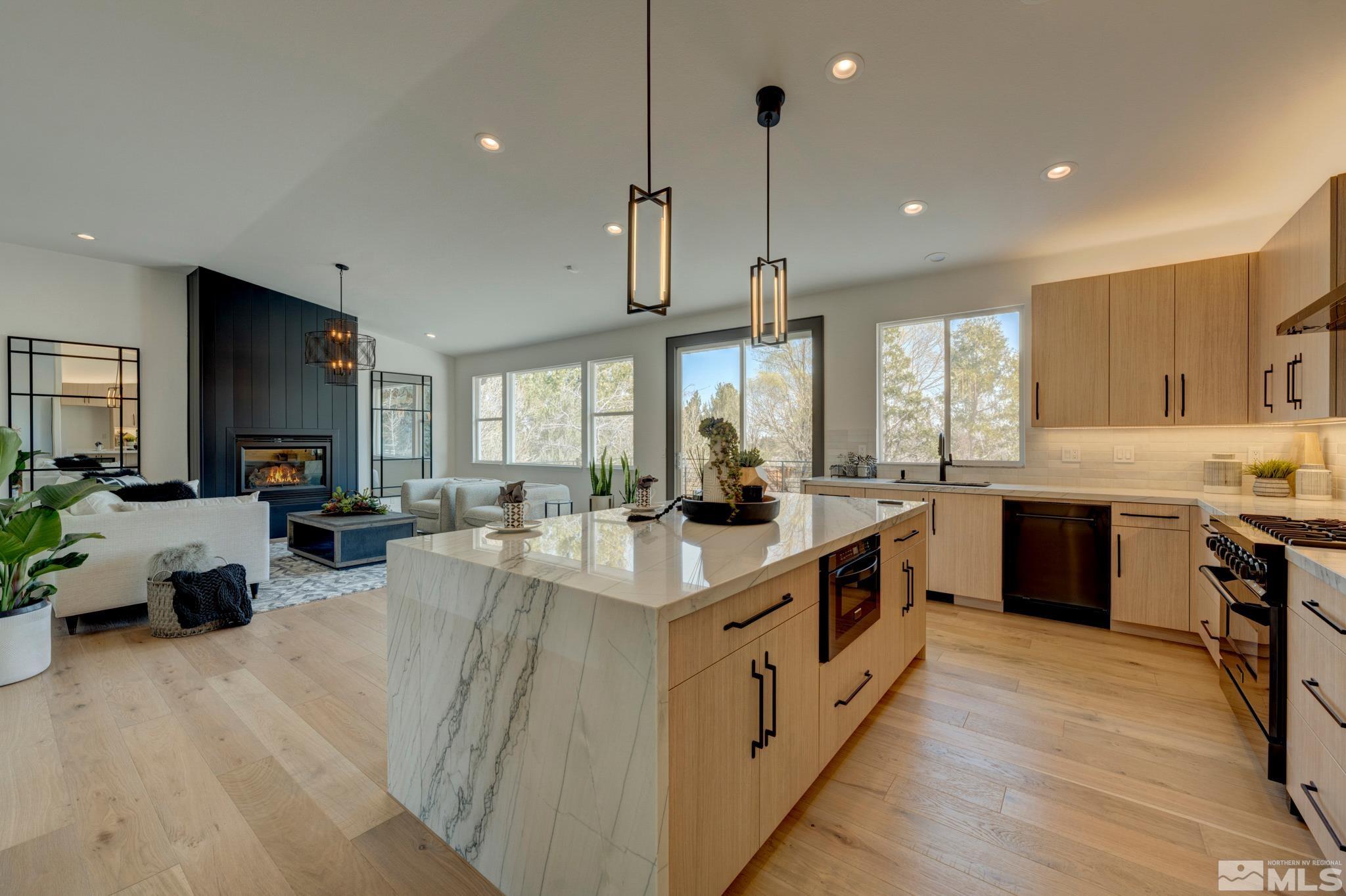 1095 Flanders Road Reno, NV 89511 - Photo 12 of 39 a large kitchen with stainless steel appliances lots of counter space and wooden floor