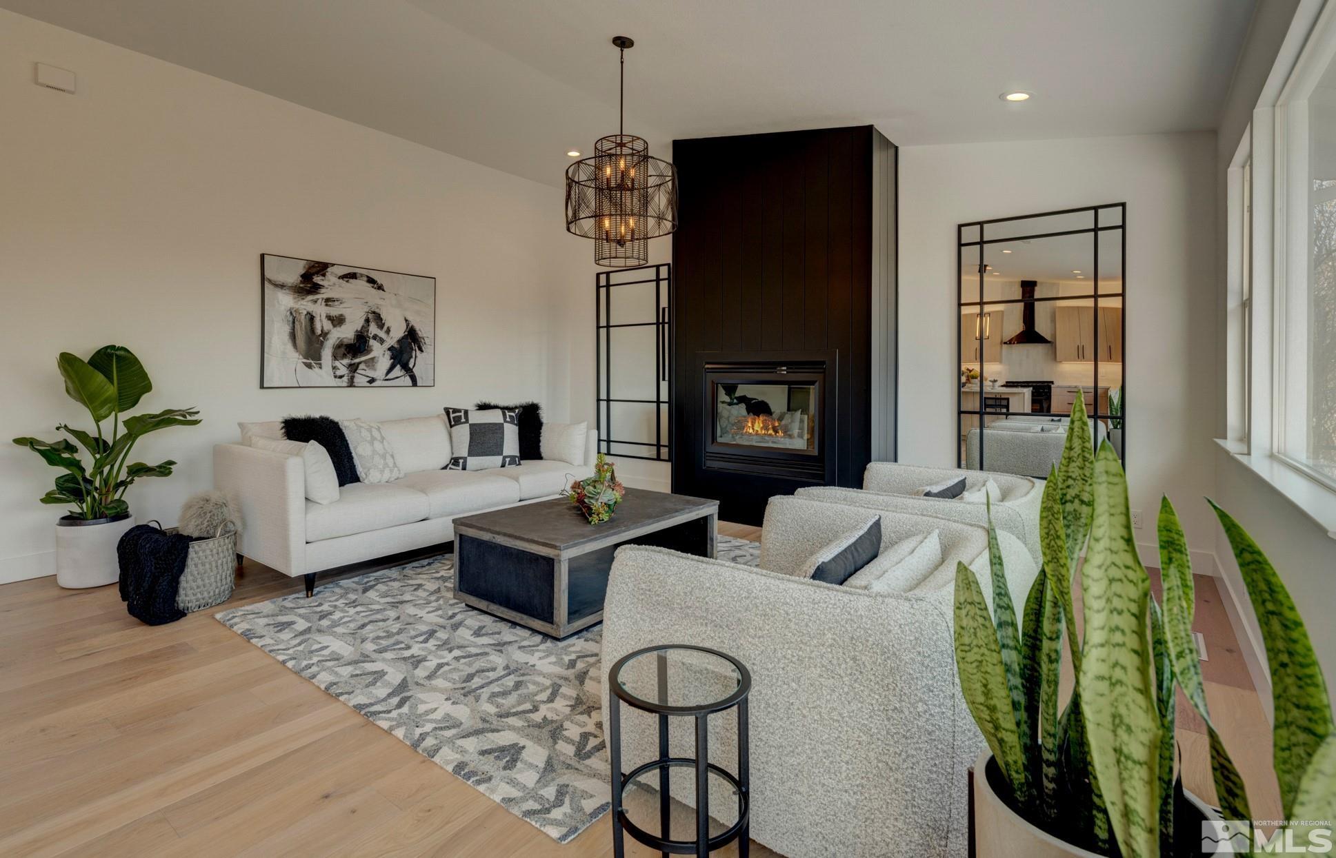 1095 Flanders Road Reno, NV 89511 - Photo 14 of 39 a living room with fireplace furniture and a potted plant