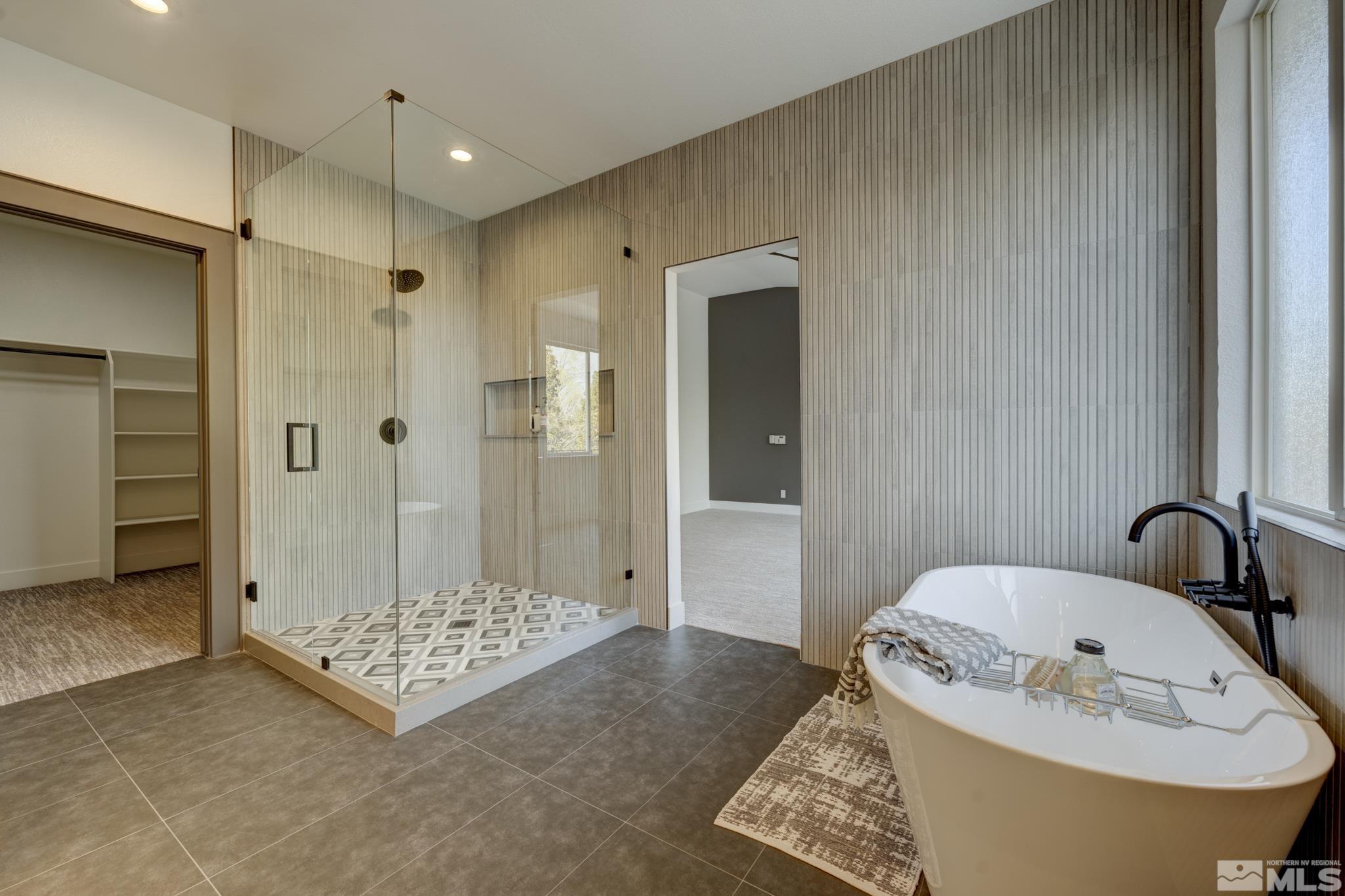 1095 Flanders Road Reno, NV 89511 - Photo 19 of 39 a bathroom with a tub and shower