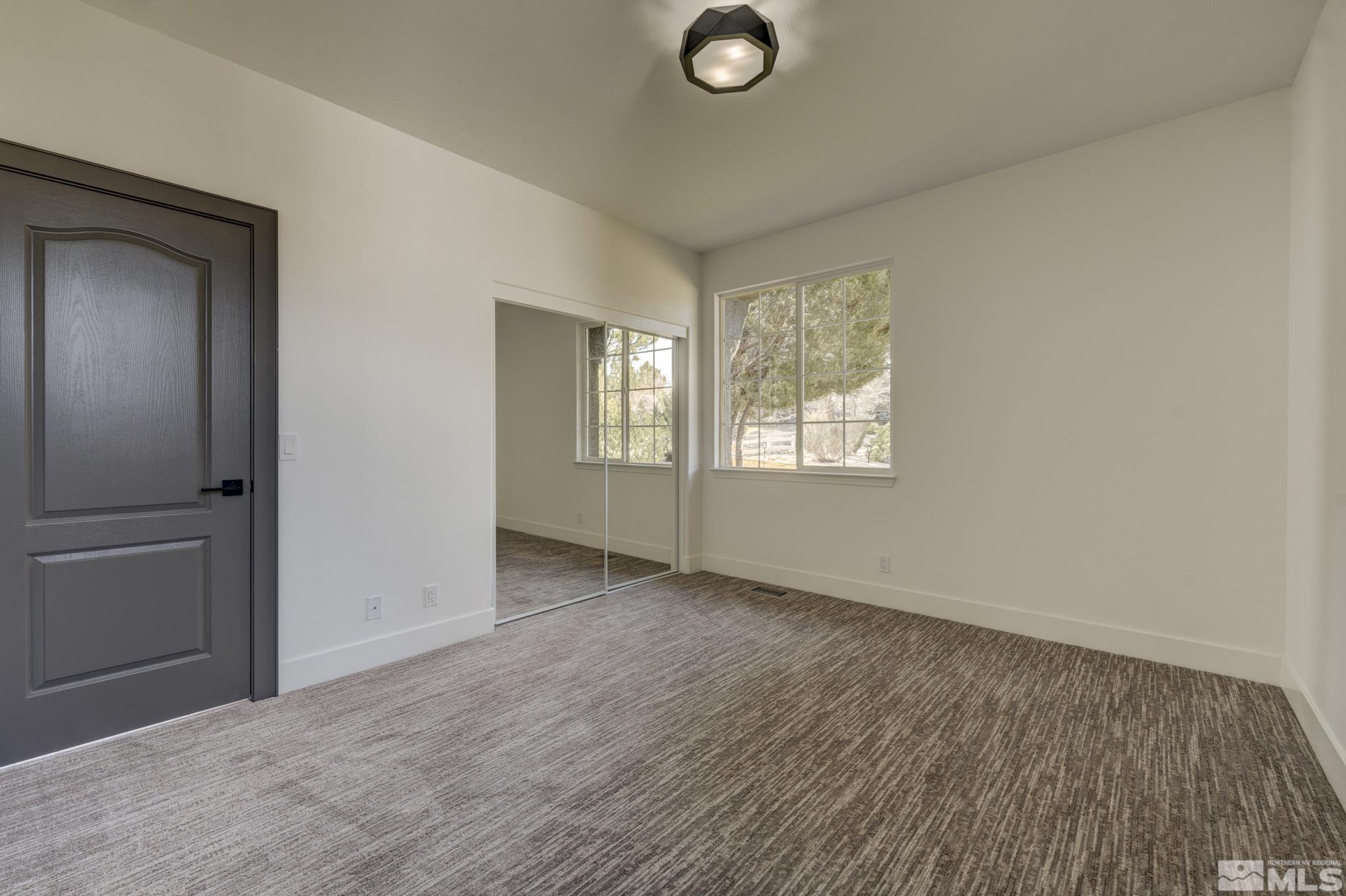1095 Flanders Road Reno, NV 89511 - Photo 22 of 39 an empty room with windows and closet