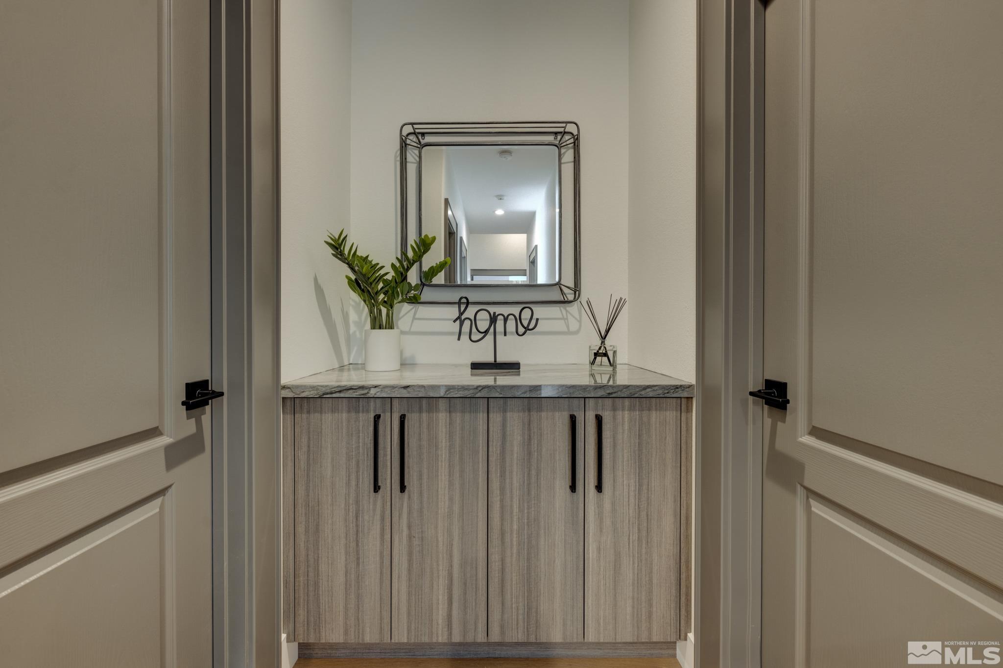 1095 Flanders Road Reno, NV 89511 - Photo 27 of 39 a bathroom with a sink a mirror and a toilet