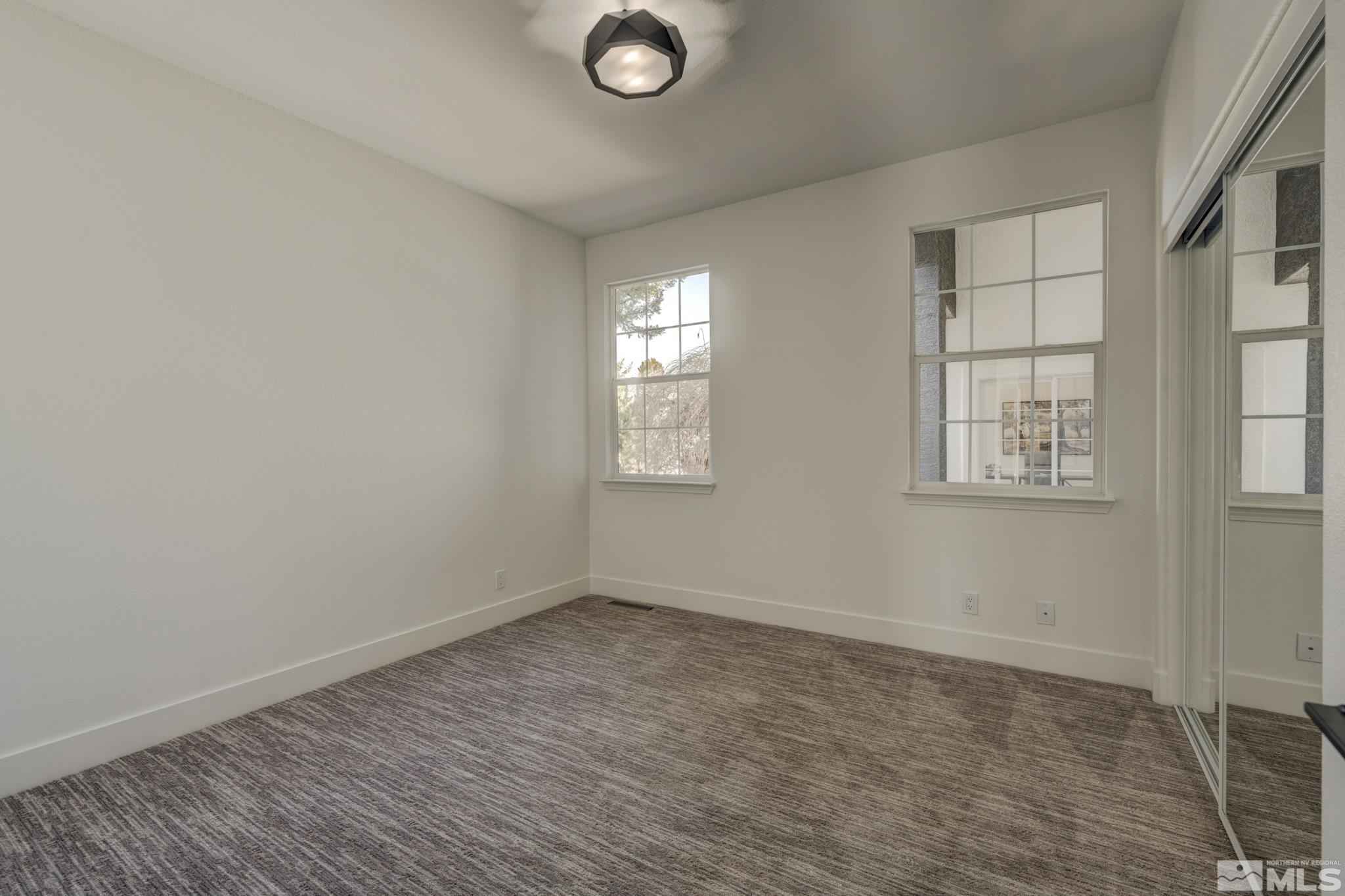 1095 Flanders Road Reno, NV 89511 - Photo 28 of 39 an empty room with windows