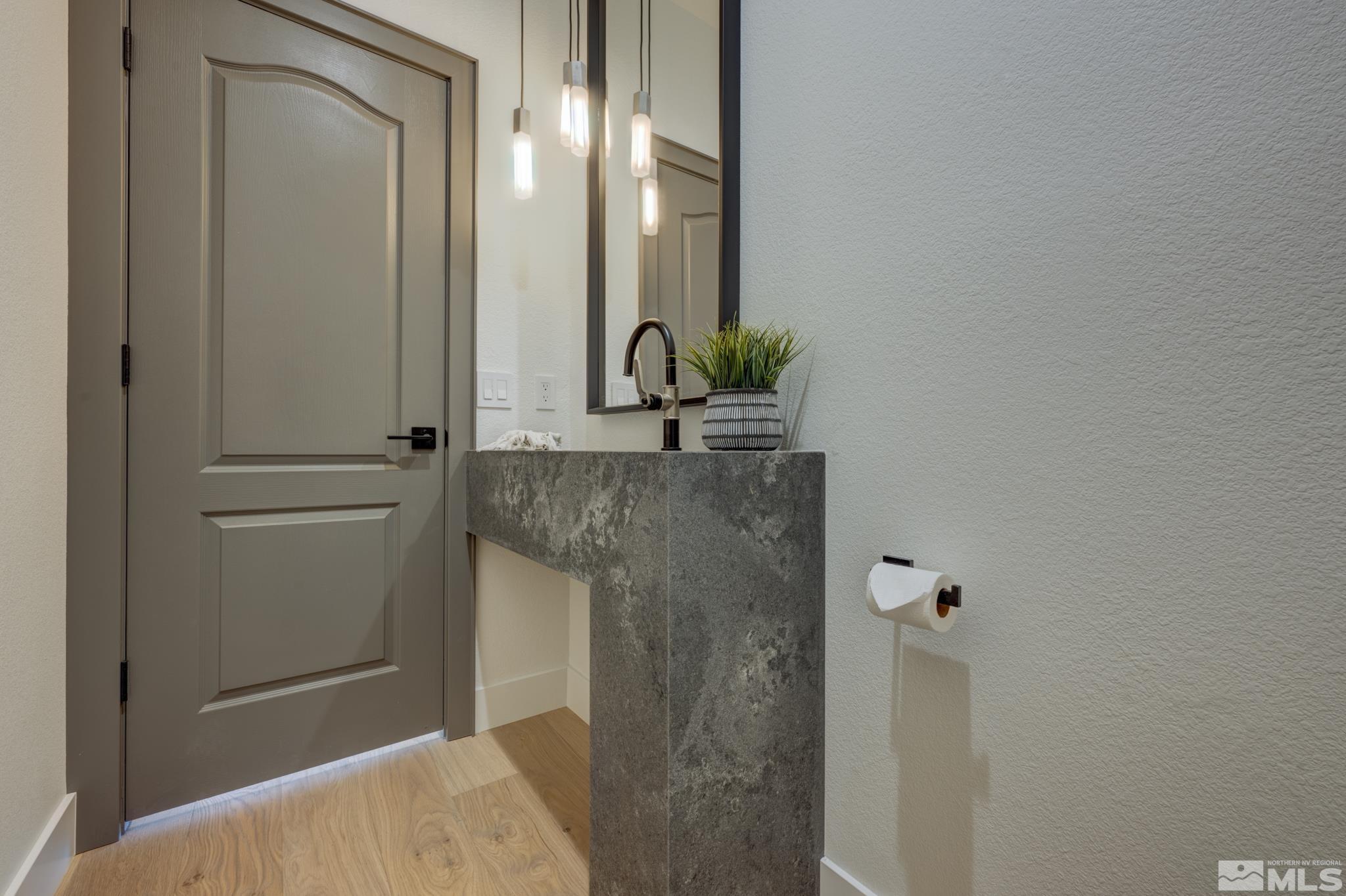 1095 Flanders Road Reno, NV 89511 - Photo 29 of 39 a bathroom with a granite countertop sink and a mirror