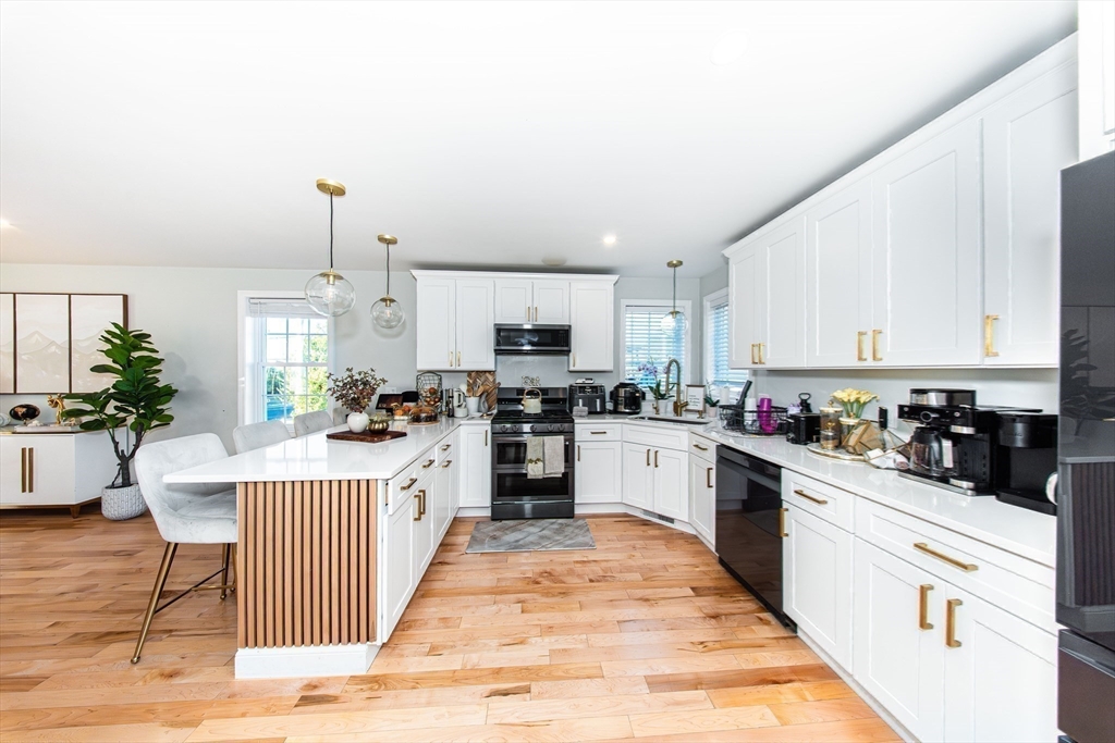 27 Vista Way Fall River, MA 02724 - Photo 15 of 33 a kitchen with white cabinets appliances and cabinets