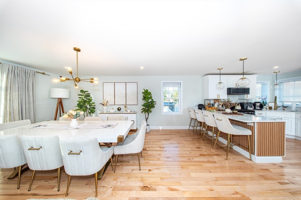 27 Vista Way Fall River, MA 02724 - Photo 18 of 33 a kitchen with stainless steel appliances kitchen island granite countertop a dining table and chairs