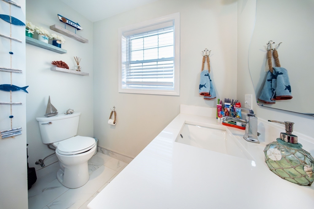 27 Vista Way Fall River, MA 02724 - Photo 20 of 33 a bathroom with a toilet sink and mirror