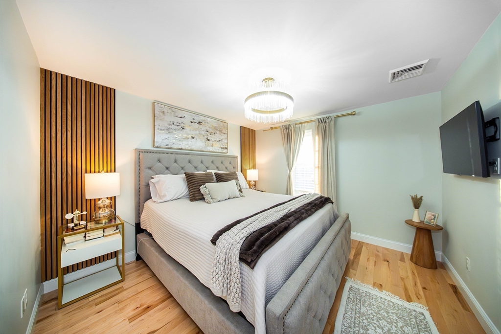 27 Vista Way Fall River, MA 02724 - Photo 24 of 33 a bedroom with a bed and a flat screen tv