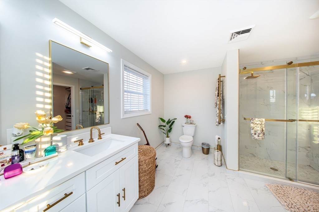 27 Vista Way Fall River, MA 02724 - Photo 27 of 33 a spacious bathroom with a shower sink and mirror