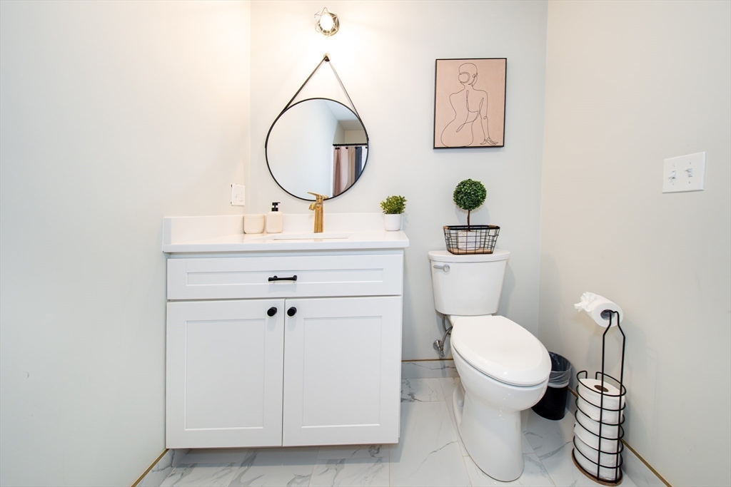27 Vista Way Fall River, MA 02724 - Photo 30 of 33 a bathroom with a toilet a sink and a mirror