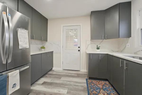 a kitchen with a refrigerator and a sink