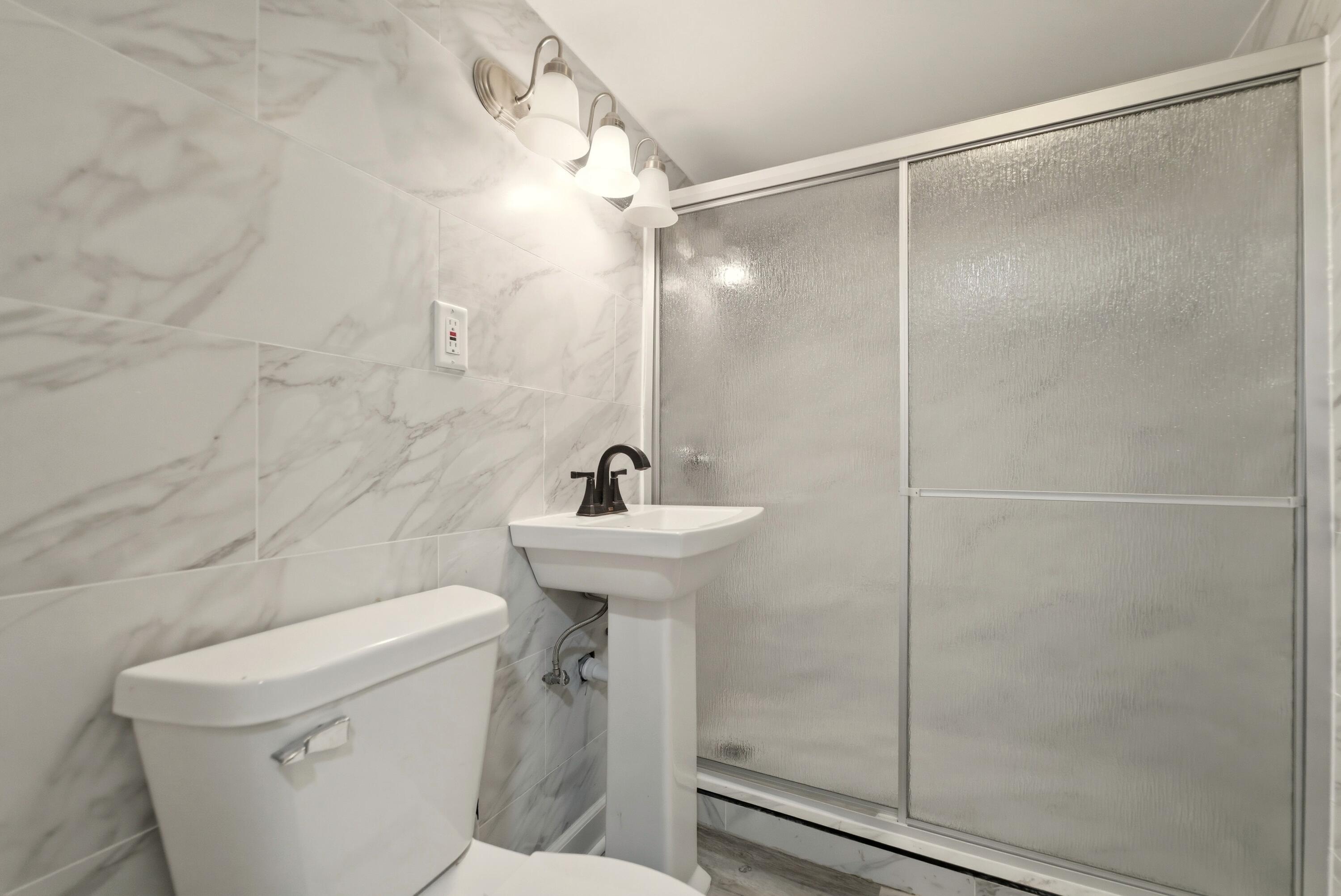 747 North Lafayette Street Griffith, IN 46319 - Photo 22 of 31 a bathroom with a sink a toilet and shower