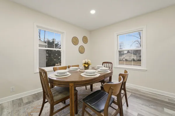 a view of a dining room with furniture and wooden floor