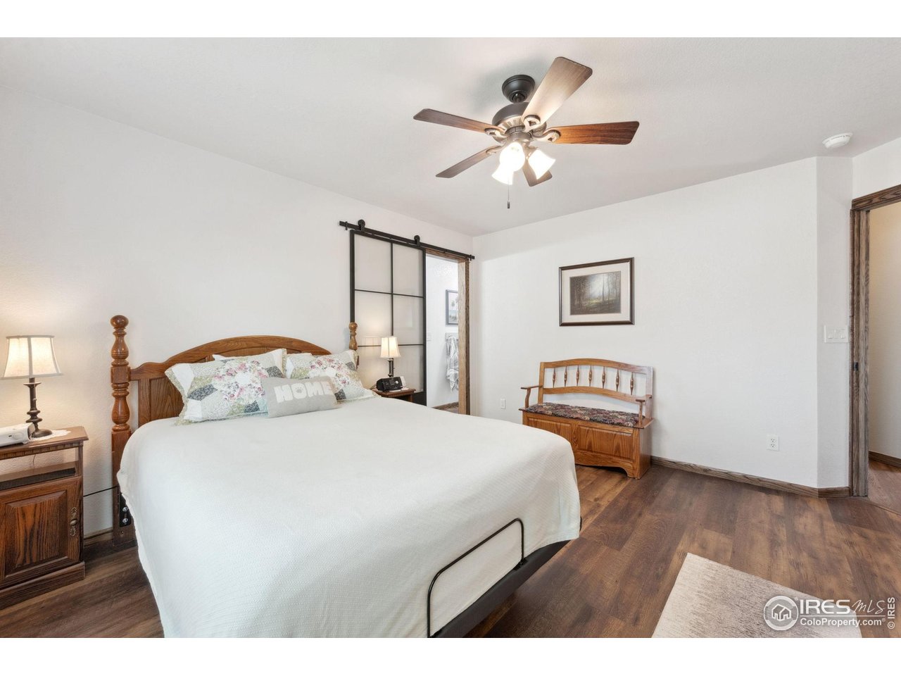 2131 68th Avenue Greeley, CO 80634 - Photo 11 of 39 a bedroom with a bed and a chandelier