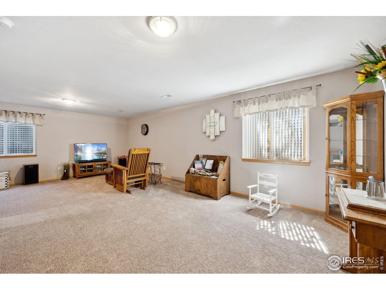 2131 68th Avenue Greeley, CO 80634 - Photo 20 of 39 a living room with furniture and a flat screen tv