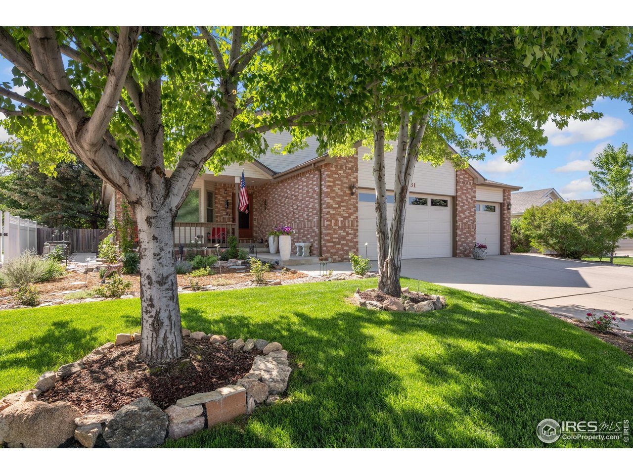 2131 68th Avenue Greeley, CO 80634 - Photo 2 of 39 a front view of a house with garden