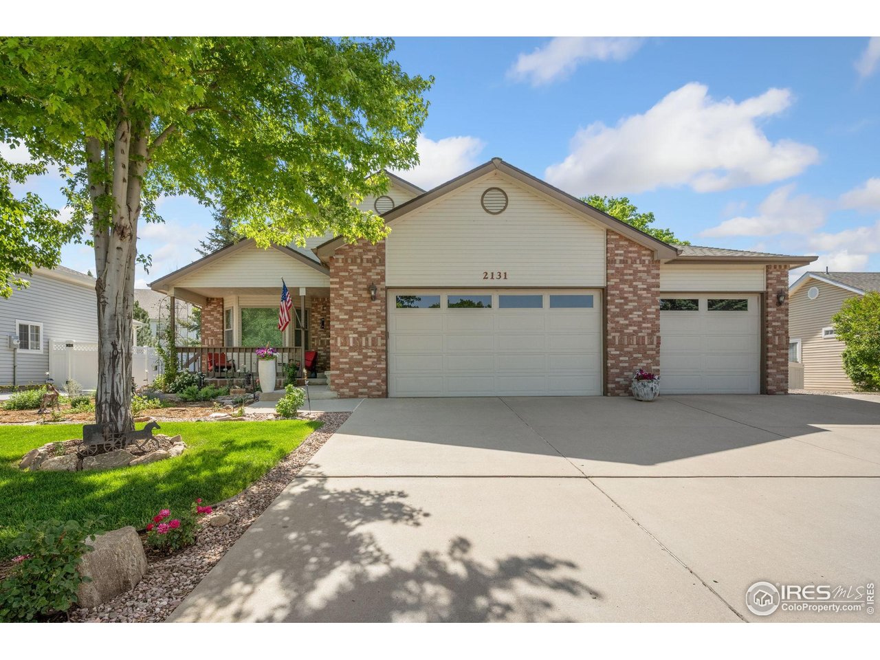 2131 68th Avenue Greeley, CO 80634 - Photo 33 of 39 a front view of a house with garden