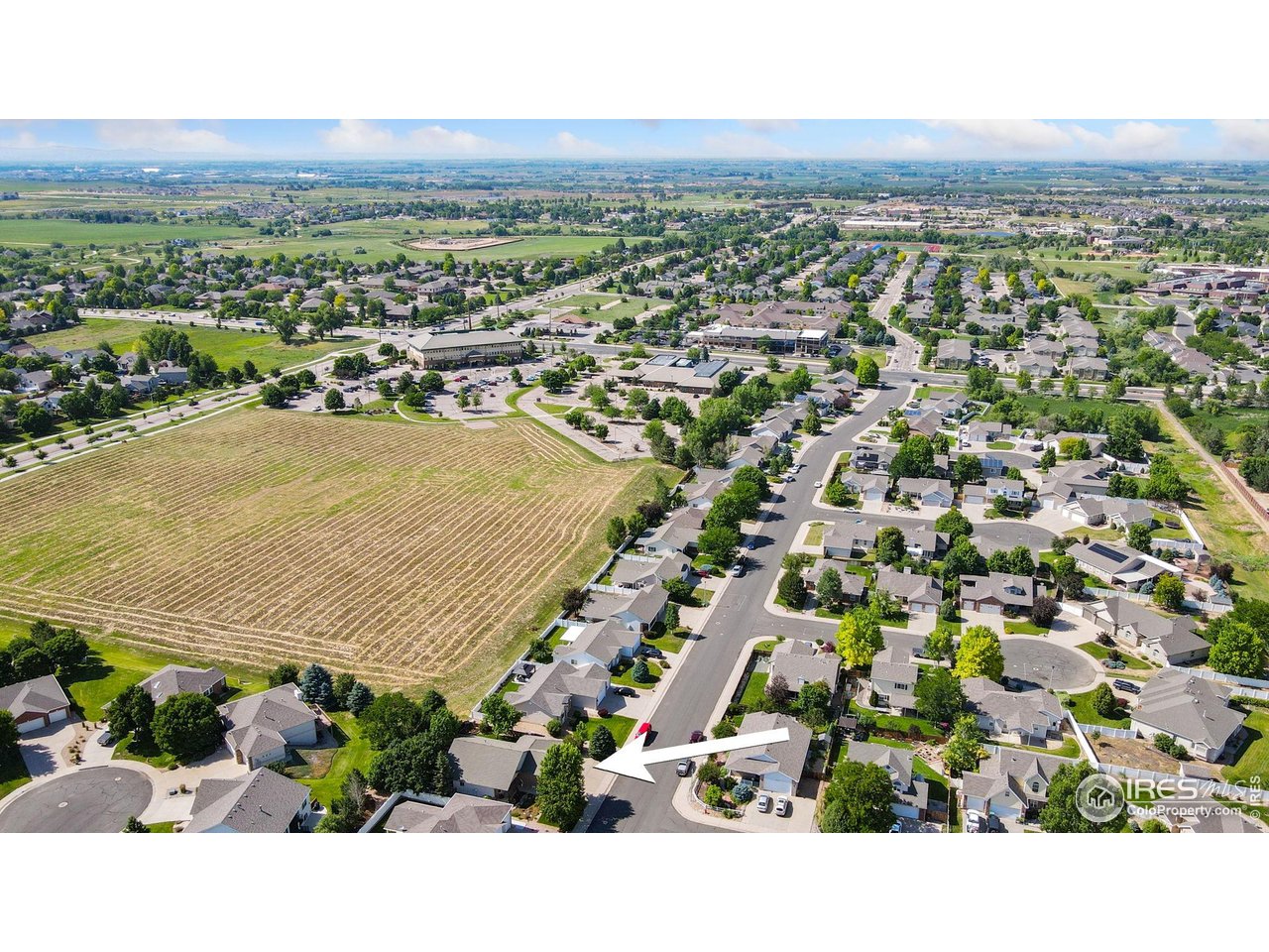 2131 68th Avenue Greeley, CO 80634 - Photo 38 of 39 an aerial view of residential houses with outdoor space and trees