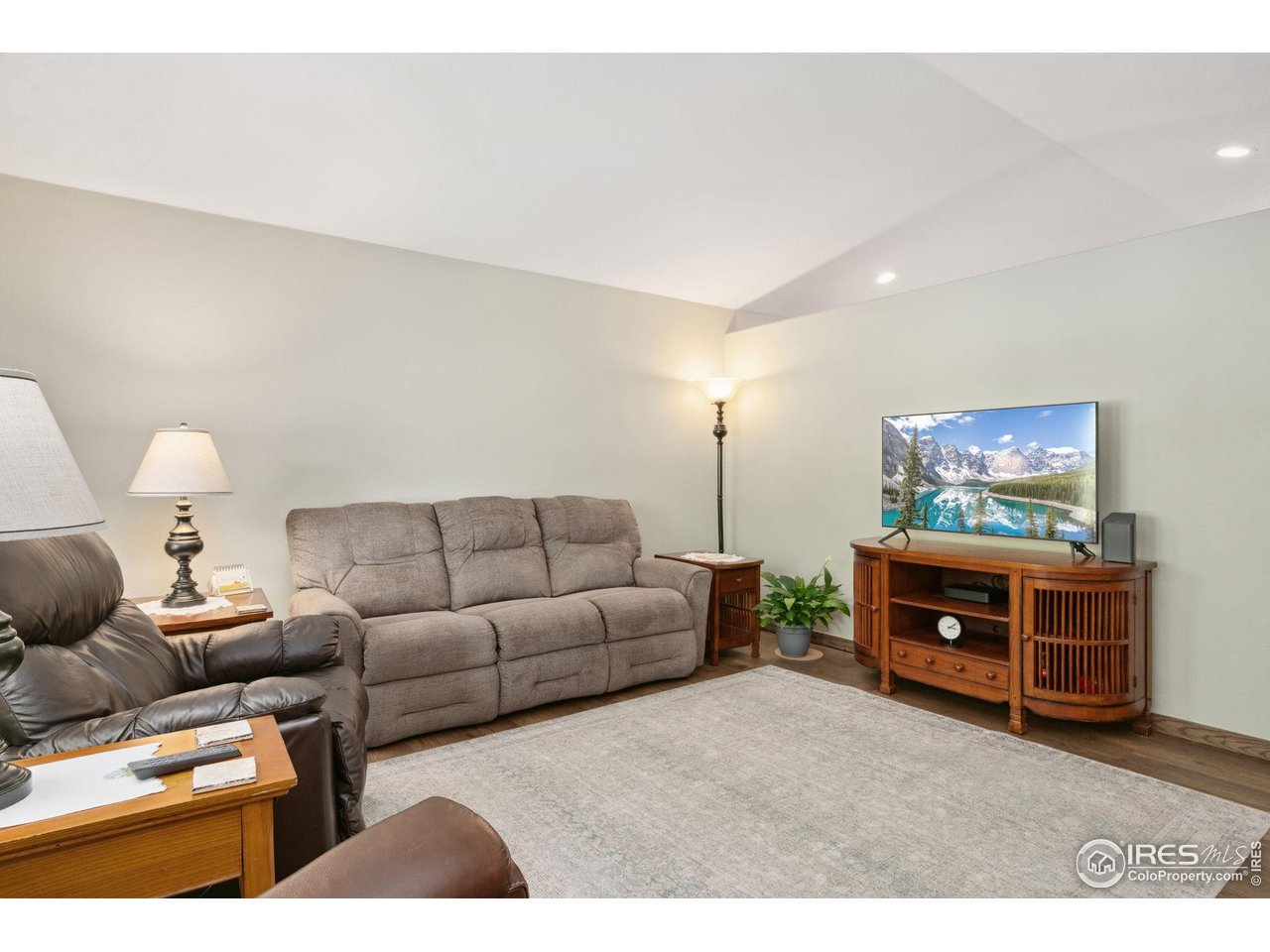 2131 68th Avenue Greeley, CO 80634 - Photo 4 of 39 a living room with furniture and a flat screen tv