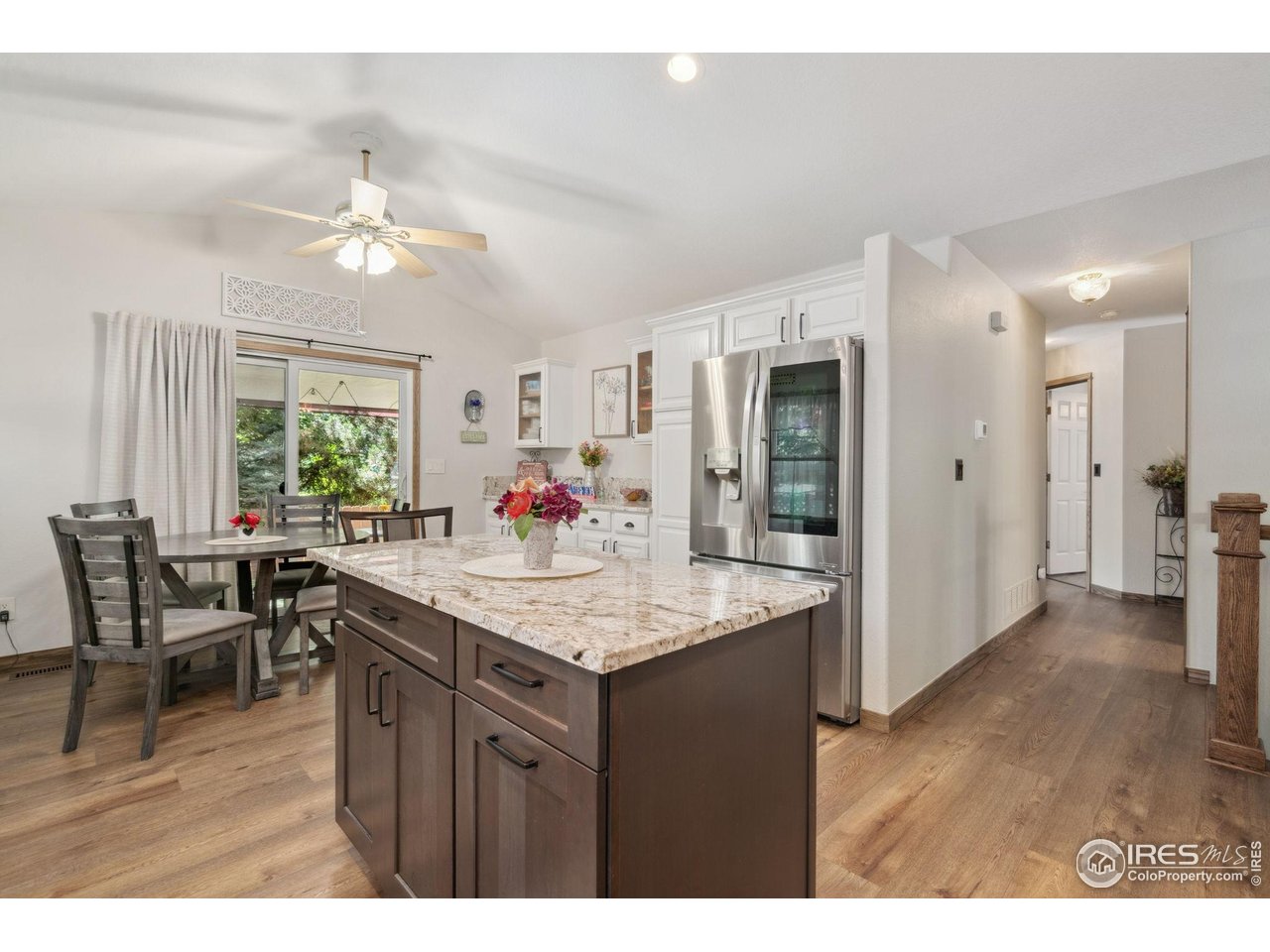 2131 68th Avenue Greeley, CO 80634 - Photo 6 of 39 a view of kitchen island dining space wooden floor and dining room