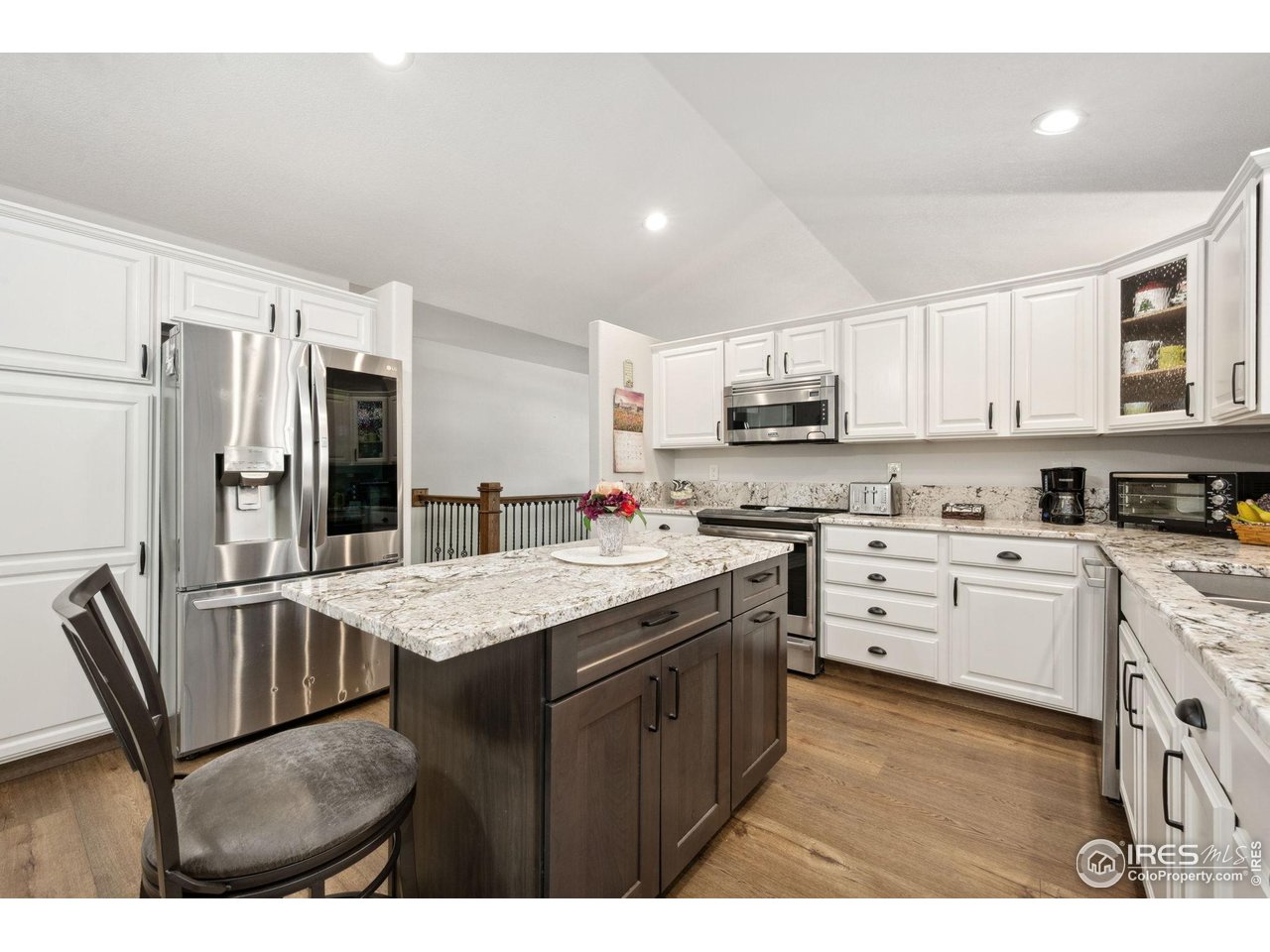 2131 68th Avenue Greeley, CO 80634 - Photo 8 of 39 a kitchen with stainless steel appliances granite countertop a sink stove and refrigerator