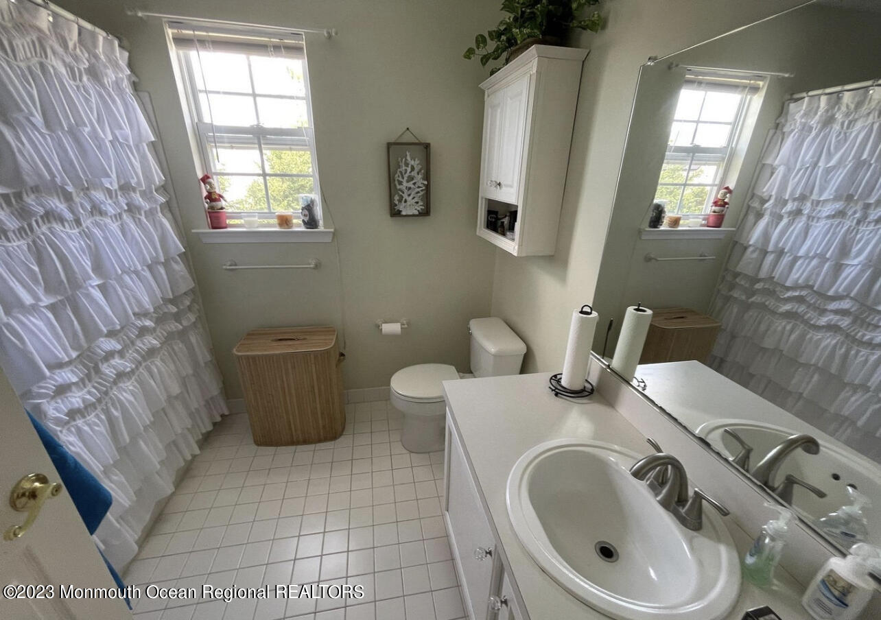 16 William Drive Howell, NJ 07731 - Photo 16 of 25 a bathroom with a sink toilet and window