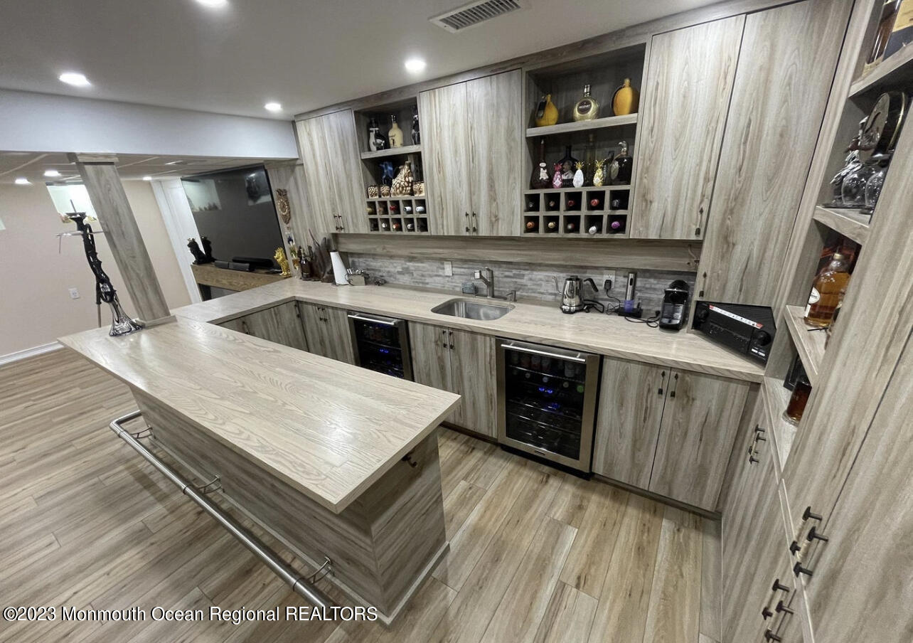 16 William Drive Howell, NJ 07731 - Photo 18 of 25 a kitchen with a stove a sink and a refrigerator