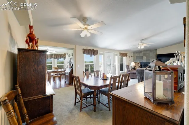 a view of a dining room with furniture and a chandelier