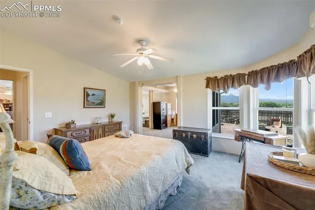 a bedroom with a large bed and a large window