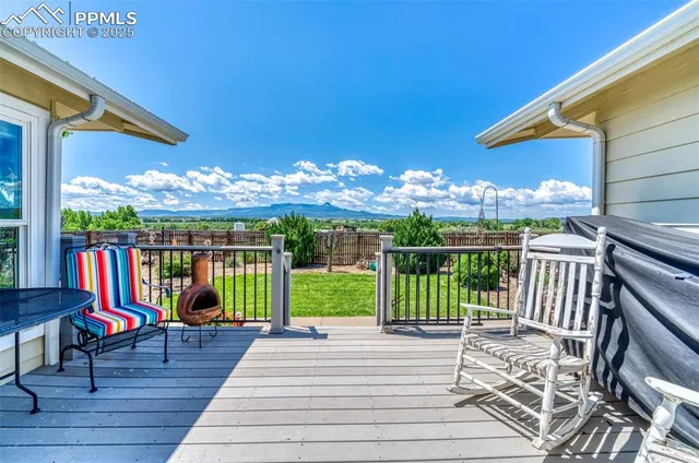 a view of a porch with furniture and garden