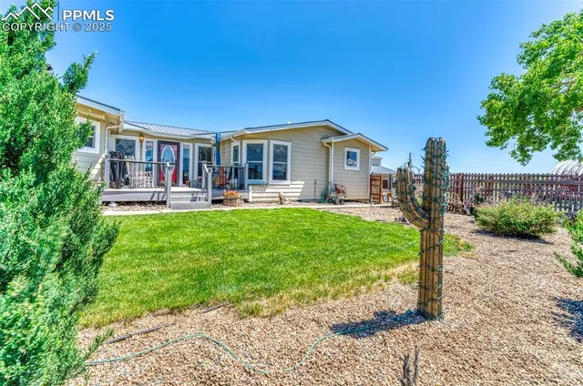 a front view of a house with a yard table and chairs