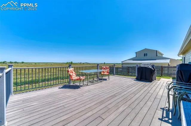 a balcony with furniture and wooden floor