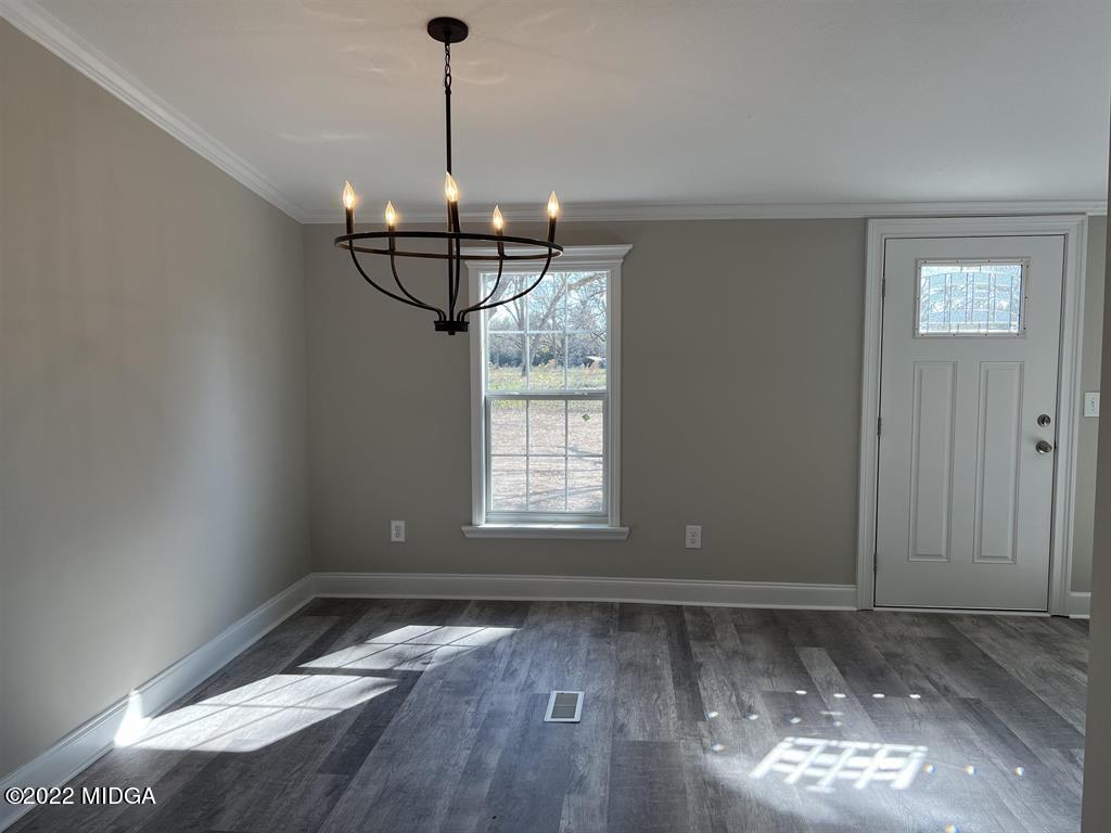 847 849 Lakeview Road Byron, GA 31008 - Photo 3 of 29 a view of a room with wooden floor chandelier and windows