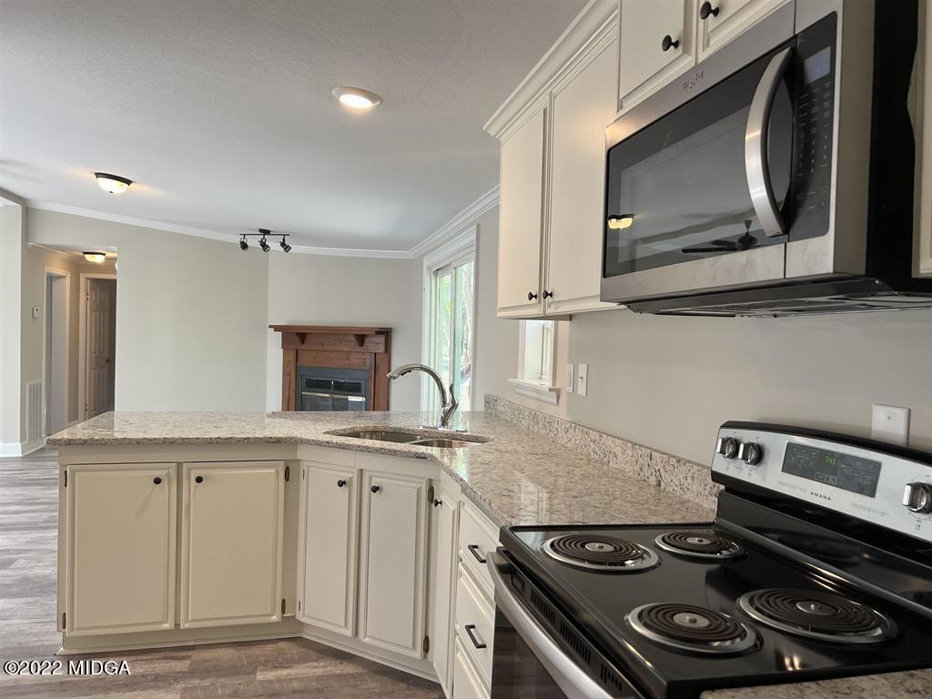 847 849 Lakeview Road Byron, GA 31008 - Photo 8 of 29 a kitchen with granite countertop stainless steel appliances and sink