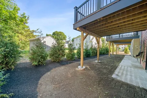 a view of a patio with table and chairs under an umbrella