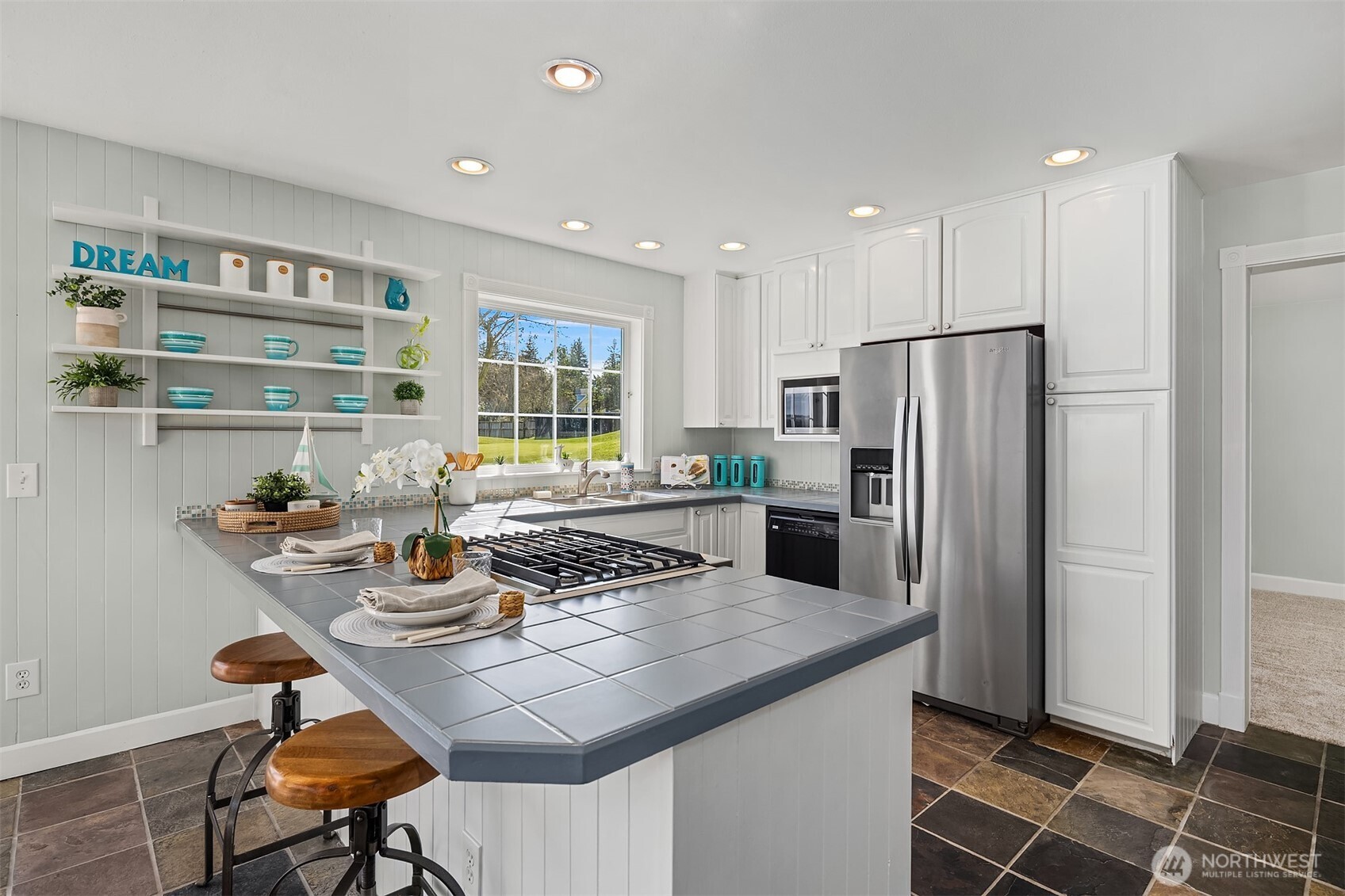 1316 East Backswing Lane Freeland, WA 98249 - Photo 15 of 34 a kitchen with refrigerator and chairs