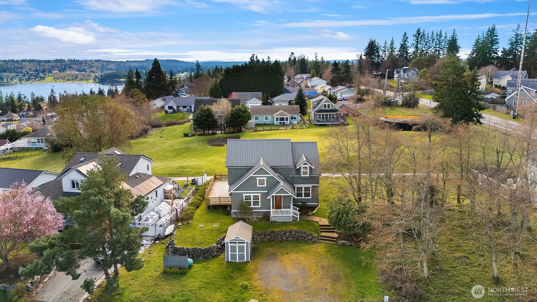 1316 East Backswing Lane Freeland, WA 98249 - Photo 4 of 34 an aerial view of a house with swimming pool and lake view