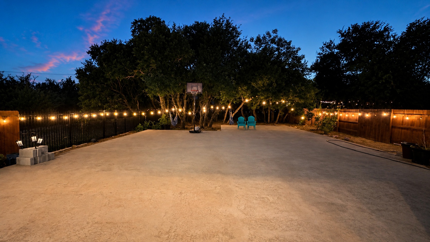 7290 Shoshoni Loop Round Rock, TX 78681 - Photo 5 of 6 A private outdoor haven with twinkling lights and a dedicated basketball court for evening recreation.