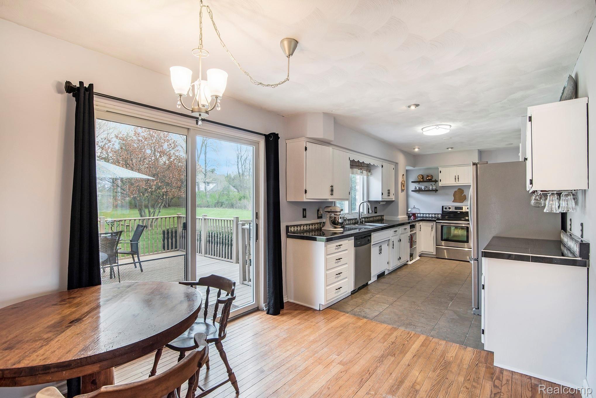 1860 Echo Hills Road Howell, MI 48855 - Photo 7 of 25 Enjoy the view to the back deck and the hardwood floors in the breakfast nook