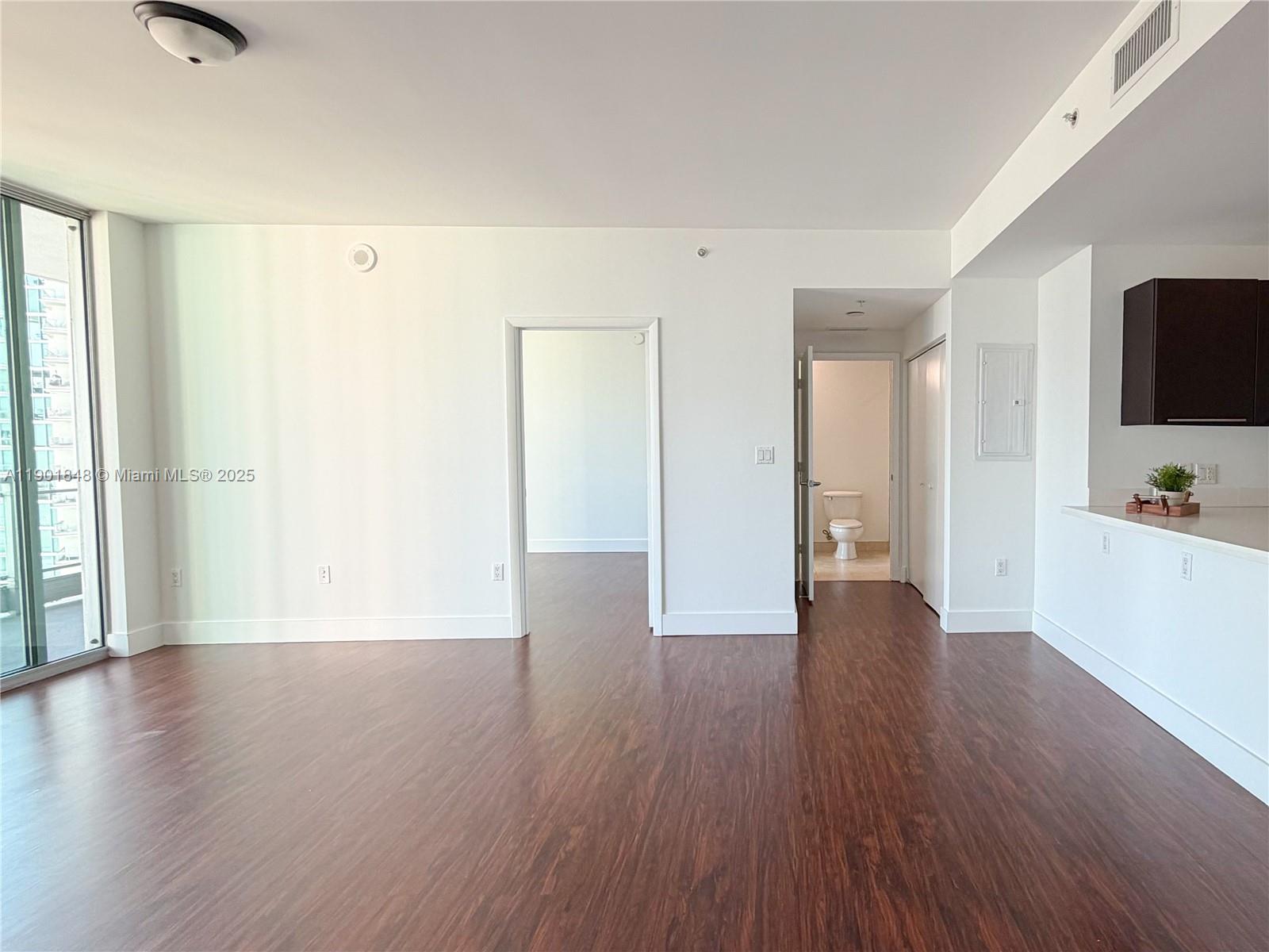 90 Southwest 3rd Street, Unit 2401 Miami, FL 33130 - Photo 11 of 68 a view of a kitchen with wooden floor and a refrigerator